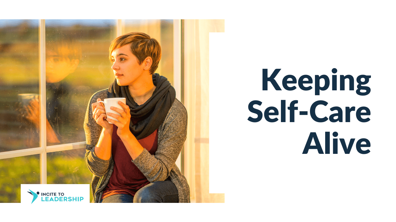 For this article by Jo Ilfeld, Executive Leadership Coach on self-care, the image shows a woman sitting by a window with a warm cup of tea or coffee in her hands.