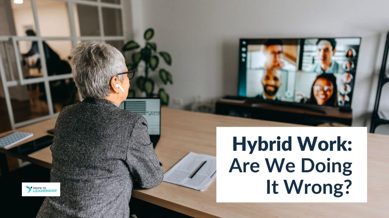 For this article by Jo Ilfeld, Executive Leadership Coach on hybrid work the image shows a business woman alone in her office in front of a large video screen showing a Zoom meeting