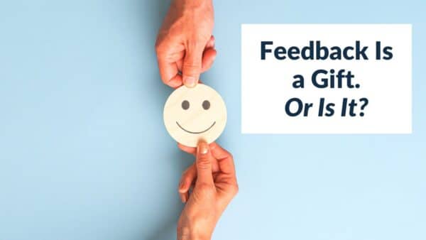For this article by Jo Ilfeld, Executive Leadership Coach on feedback as a gift the image shows a hand offering a drawing of a smiley face icon.