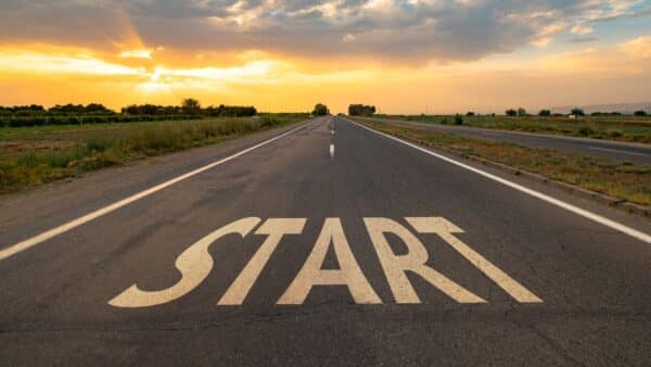 For this article by Jo Ilfeld, Executive Leadership Coach on starting strong in a new job the image shows an empty road with the words start on it.
