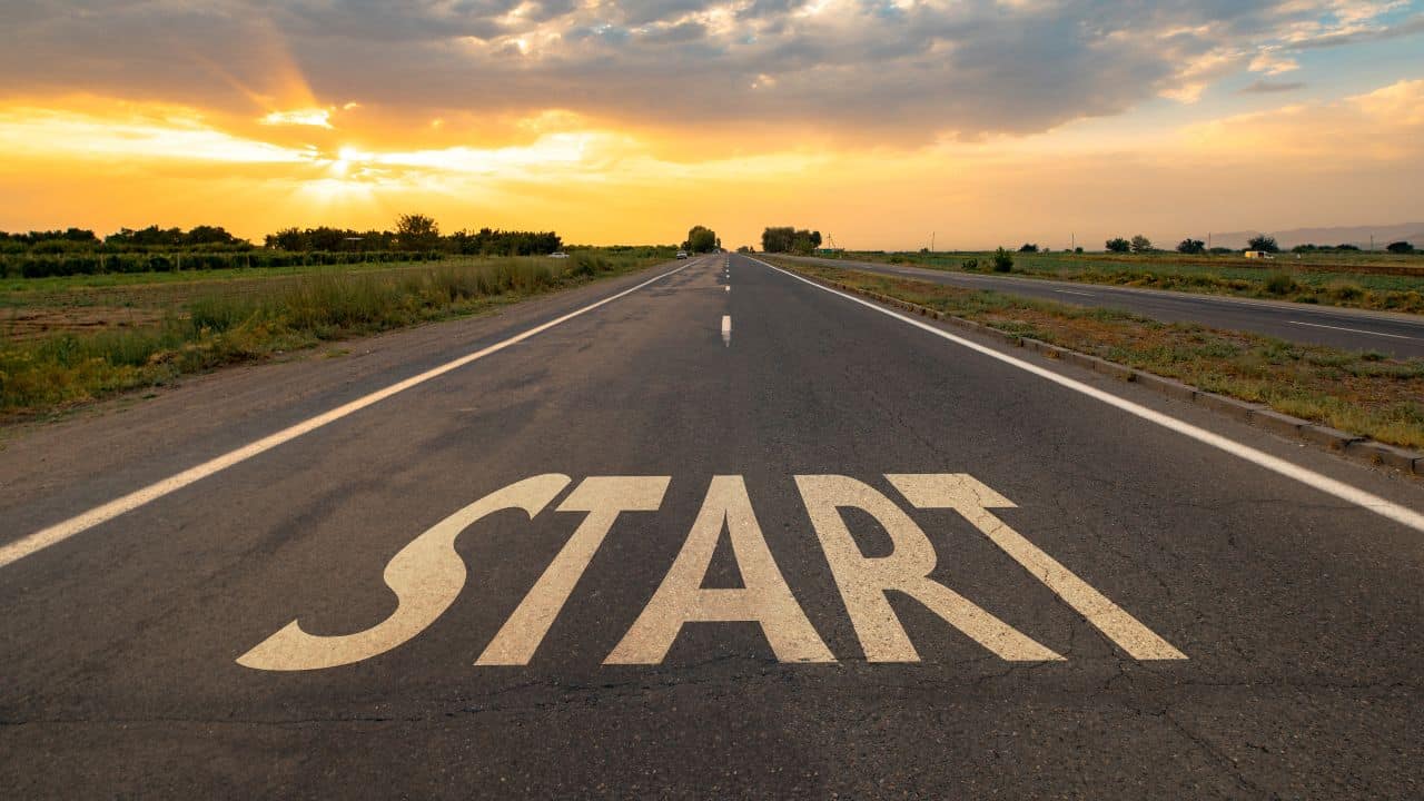 For this article by Jo Ilfeld, Executive Leadership Coach on starting strong in a new job the image shows an empty road with the words start on it.